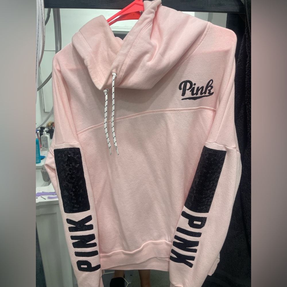 Pink pullover sweater with black sequence letters